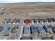 Drone image of symmetrical homes in a modern community, set against a natural landscape with visible solar panels at 8187 Mount Kataka St, Littleton, CO 80125