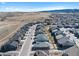 Scenic aerial view of a suburban neighborhood, showcasing rooftops and mountain views against a clear blue sky at 8187 Mount Kataka St, Littleton, CO 80125