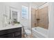 Bright bathroom with tub-shower combo, modern vanity, and neutral tile, offering a clean, modern look at 8187 Mount Kataka St, Littleton, CO 80125