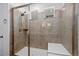 Contemporary tiled shower with glass enclosure and bench seating for comfortable showering at 8187 Mount Kataka St, Littleton, CO 80125