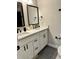 Bathroom featuring double sinks and black fixtures at 7810 W 87Th Dr # E, Arvada, CO 80005