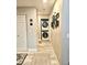 Hallway with laundry area, neutral paint, stylish rugs and streamlined design at 7810 W 87Th Dr # E, Arvada, CO 80005