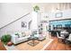 Bright living room featuring a modern design, high ceilings, and a beautiful open floor plan adjacent to the kitchen area at 7525 E 1St Pl # 1010, Denver, CO 80230