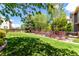 Serene backyard featuring a lush green lawn, mature trees, and a classic wooden fence at 7234 S Kellerman Way, Aurora, CO 80016