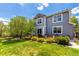 Beautiful backyard with a well-maintained lawn, mature trees, and outdoor seating area, perfect for entertaining at 7234 S Kellerman Way, Aurora, CO 80016