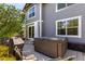 Outdoor living with a hot tub and barbecue on a stone patio, ideal for relaxation and entertaining at 7234 S Kellerman Way, Aurora, CO 80016
