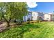Expansive backyard with lush green grass and mature trees, offering a serene and private outdoor space at 7234 S Kellerman Way, Aurora, CO 80016