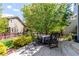 Inviting outdoor patio with a dining set, lush greenery, and a charming house backdrop at 7234 S Kellerman Way, Aurora, CO 80016