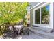 Backyard patio with dining set adjacent to sliding glass doors, set under a shade tree at 7234 S Kellerman Way, Aurora, CO 80016