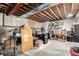 Unfinished basement offering open space with exposed ceiling and ample storage potential at 7234 S Kellerman Way, Aurora, CO 80016
