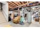 Unfinished basement with utilities, stairs, and exposed ceiling, awaiting your personal touch at 7234 S Kellerman Way, Aurora, CO 80016