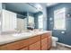 Brightly painted bathroom with double sinks and a decorative nautical theme at 7234 S Kellerman Way, Aurora, CO 80016