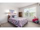 Comfortable bedroom with large window offering abundant natural light at 7234 S Kellerman Way, Aurora, CO 80016