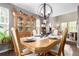 Formal dining area with hardwood floors, updated lighting, and ample natural light with an open floor plan at 7234 S Kellerman Way, Aurora, CO 80016
