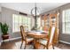 Formal dining room featuring hardwood floors, a modern chandelier, and a wooden hutch for storage at 7234 S Kellerman Way, Aurora, CO 80016