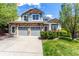 Charming two-story home with stone accents, a two-car garage, and a well-manicured lawn at 7234 S Kellerman Way, Aurora, CO 80016