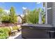Relaxing backyard patio with a hot tub and comfortable seating, ideal for enjoying a peaceful outdoor experience at 7234 S Kellerman Way, Aurora, CO 80016