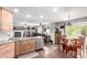 Open floor plan with kitchen island and dining area flowing into the living room with fireplace at 7234 S Kellerman Way, Aurora, CO 80016