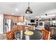 Kitchen and dining area with wooden cabinets, stainless steel appliances, and sleek countertops at 7234 S Kellerman Way, Aurora, CO 80016
