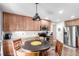 Well-lit kitchen featuring wooden cabinets, modern appliances, and a breakfast table at 7234 S Kellerman Way, Aurora, CO 80016