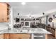 Granite countertops and sink with a view into the living room with fireplace at 7234 S Kellerman Way, Aurora, CO 80016