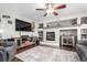 Cozy living room with a ceiling fan, stylish fireplace, and entertainment center at 7234 S Kellerman Way, Aurora, CO 80016