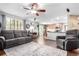 Comfortable living room featuring hardwood floors, a ceiling fan and access to the kitchen at 7234 S Kellerman Way, Aurora, CO 80016