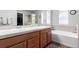 Well-lit main bathroom with double vanity, soaking tub, and separate shower at 7234 S Kellerman Way, Aurora, CO 80016