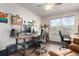 Functional office space with wood floors, a ceiling fan, and dual workstations by a bright window at 7234 S Kellerman Way, Aurora, CO 80016