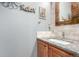 Charming powder room with stylish vanity, granite countertops and decorative mirror at 7234 S Kellerman Way, Aurora, CO 80016