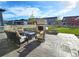 Inviting backyard with a stone fireplace, stamped concrete patio, and comfortable seating area at 7195 S Yantley Way, Aurora, CO 80016