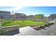 Immaculate backyard featuring lush green lawn, white fencing, and professionally landscaped garden beds at 7195 S Yantley Way, Aurora, CO 80016