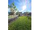 Lush backyard featuring healthy lawn, decorative rock and white fencing in a well manicured suburban landscape at 7195 S Yantley Way, Aurora, CO 80016