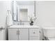 Bathroom features a sleek white vanity with a decorative mirror and fixtures at 7195 S Yantley Way, Aurora, CO 80016