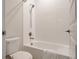 Clean bathroom with a white tiled shower-tub combination, a toilet and a vanity at 7195 S Yantley Way, Aurora, CO 80016