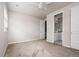 An empty, carpeted bedroom with an open door to the bathroom and a ceiling fan at 7195 S Yantley Way, Aurora, CO 80016
