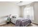 Cozy bedroom featuring a patterned comforter, accent pillows, and white-trimmed headboard at 7195 S Yantley Way, Aurora, CO 80016