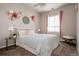 Bedroom decorated with floral arrangements and a window with pink curtains and a padded bench at 7195 S Yantley Way, Aurora, CO 80016