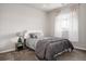 Cozy bedroom featuring a comfortable bed with stylish patterned bedding and soft gray accents at 7195 S Yantley Way, Aurora, CO 80016