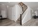 Bright entryway features hardwood floors, staircase and a crisp white color palette for a modern and airy feel at 7195 S Yantley Way, Aurora, CO 80016