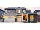 Charming two-story home featuring a three-car garage and inviting front porch at 7195 S Yantley Way, Aurora, CO 80016