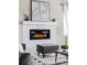 Close-up of a modern fireplace with a white mantle and elegant decor at 7195 S Yantley Way, Aurora, CO 80016