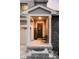 Covered front porch with welcome sign and black front door adorned with a decorative wreath at 7195 S Yantley Way, Aurora, CO 80016