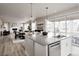 Spacious kitchen island featuring pendant lighting and stainless steel dishwasher at 7195 S Yantley Way, Aurora, CO 80016