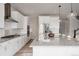 Well-equipped kitchen boasts granite countertops, stainless steel appliances, and white cabinetry at 7195 S Yantley Way, Aurora, CO 80016