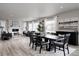 Open-concept living and dining area with hardwood floors, fireplace, large windows, and modern decor at 7195 S Yantley Way, Aurora, CO 80016