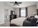 Comfortable main bedroom with dark furniture, fan, and a view to the ensuite bath, offering a peaceful retreat at 7195 S Yantley Way, Aurora, CO 80016