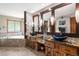 Luxury bathroom featuring dual vessel sinks with granite countertops, decorative mirrors, and a soaking tub at 8662 Kim Ct, Parker, CO 80134