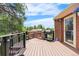 Outdoor deck featuring a built in BBQ kitchen, stainless steel grill, and a back door entry to the home at 8662 Kim Ct, Parker, CO 80134