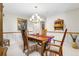 Classic dining room featuring wooden table and chairs, accented with decorative wainscoting and a stylish chandelier at 8662 Kim Ct, Parker, CO 80134
